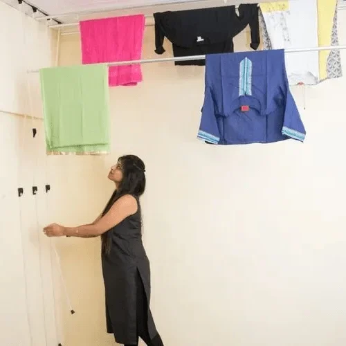 Indoor pulley-operated drying rack installed in a modern balcony